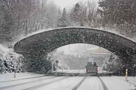 photo of white vehicle crossing a tunnel